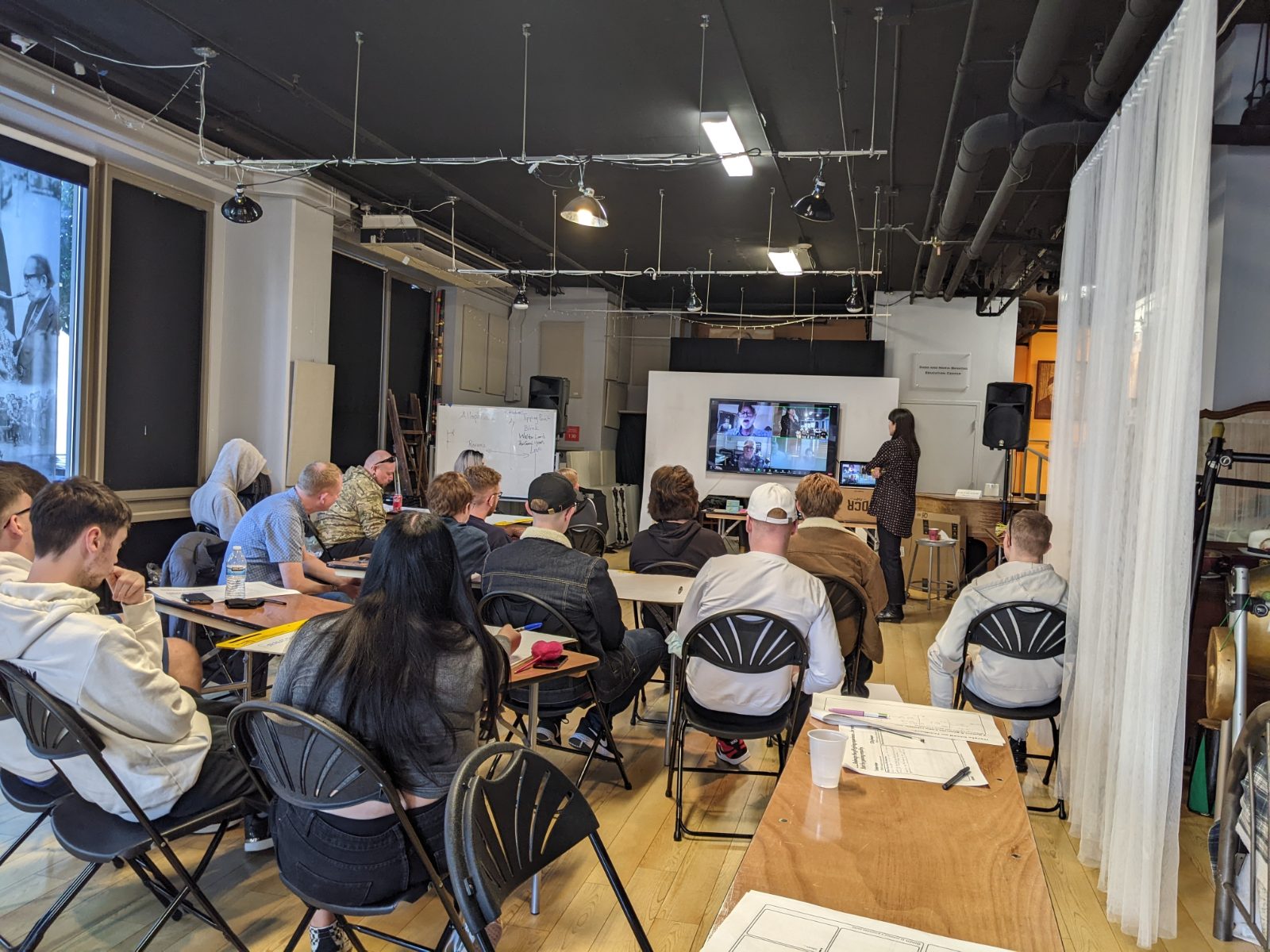 Participants in a seminar with a live video link to international speakers